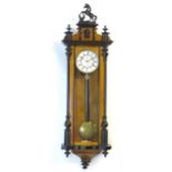 A walnut cased Vienna regulator wall clock with enamel dial. Approx. 49" high Please Note - we do