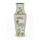 A Chinese famille verte vase decorated with panelled decoration depicting figures, elders and