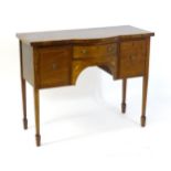 An early 20thC sideboard of small proportions, having a bow fronted and crossbanded top above a