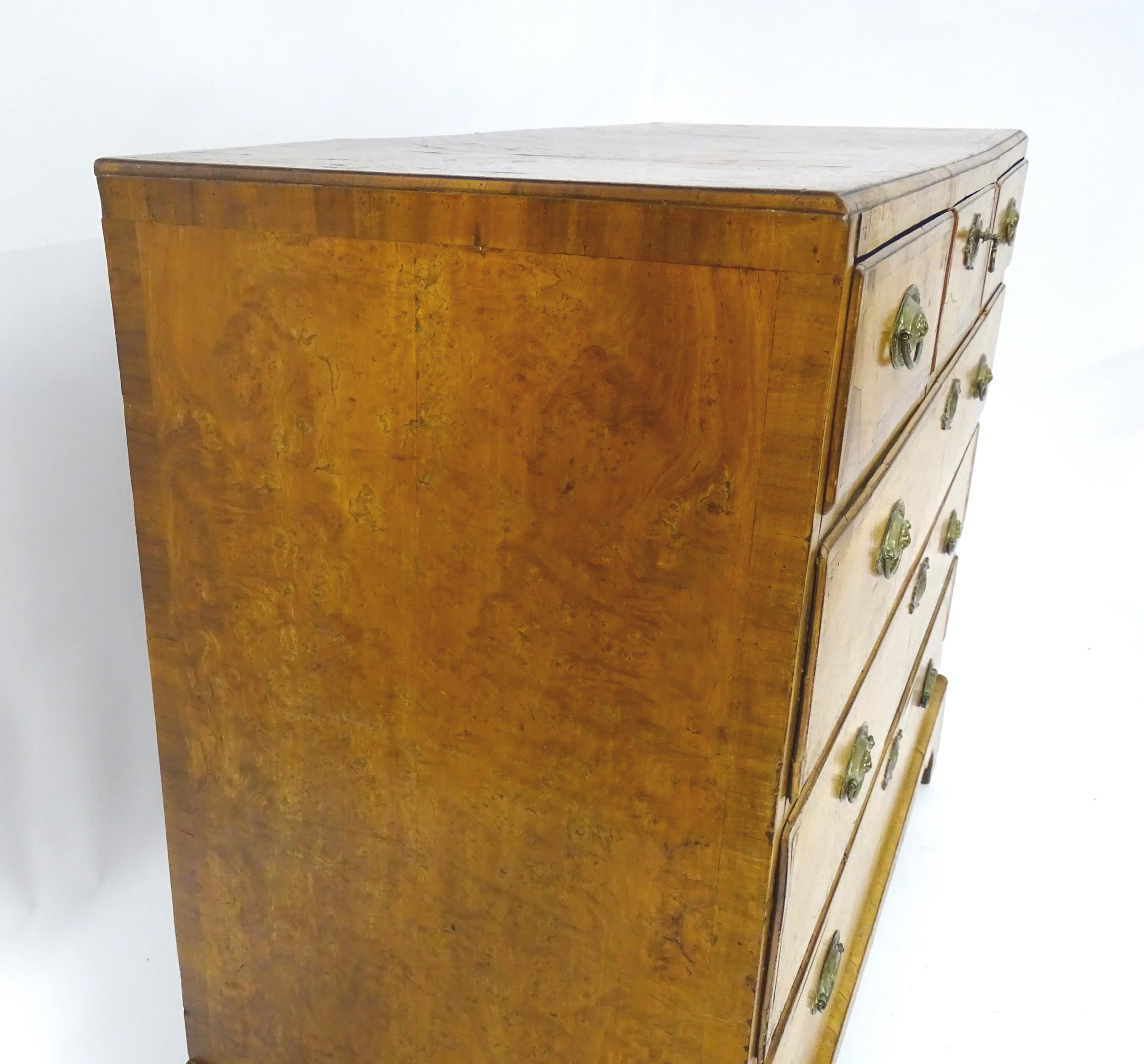 A George III walnut chest of drawers, the chest having a crossbanded top above three short over - Image 8 of 12