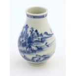 A Chinese blue and white vase decorated with a landscape scene with mountains, pagodas, figures in