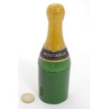 A 20thC French novelty ceramic mustard pot formed as a champagne bottle. Approx. 6 1/2" high