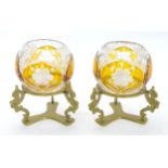 A pair of cut glass posy vases with clear and amber detail on gilt metal triform stands. Approx 7"