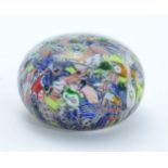 A glass Millefiori paperweight. Approx 2" high Please Note - we do not make reference to the