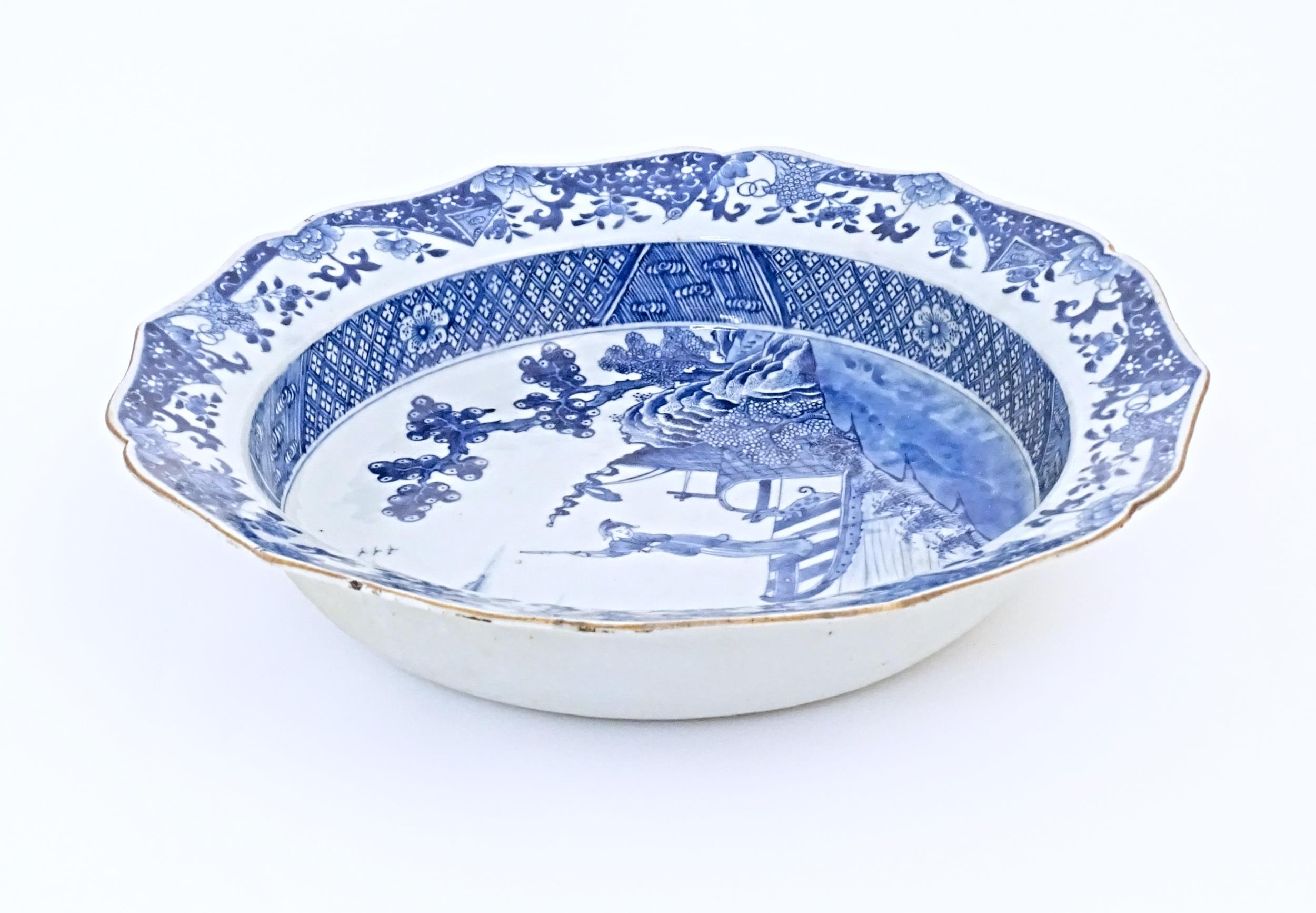 A Chinese blue and white bowl with shaped rim, decorated with a coastal scene with a figure and a - Image 8 of 8