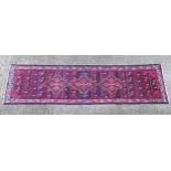 Carpet / rug : A North West Persian Hamadan Runner worked in reds, pinks, blue and cream with