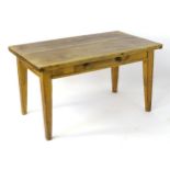 A Victorian pine farmhouse kitchen table, the rustic planked top above a single short drawer with