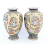 A pair of Japanese Satsuma vases of baluster form decorated with a central female figure bordered by