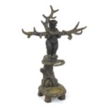 A Black Forest style stick stand / coat stand / hall stand in the form of a bear holding a branch