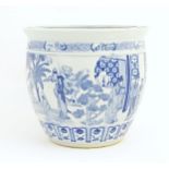 An Oriental style blue and white planter / jardiniere decorated with female figures in a garden