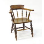 A late 19thC smokers bow chair of ash, elm and beech construction. The chair having a bowed backrest