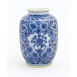 A small Chinese blue and white vase decorated with flowers and foliage in a geometric framework.