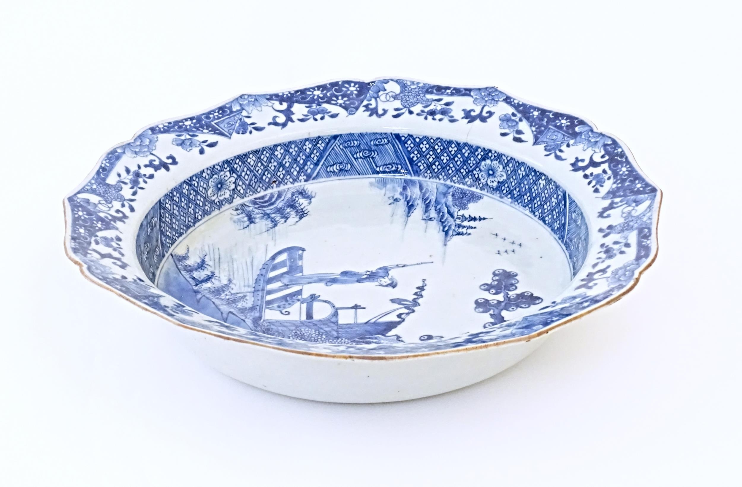 A Chinese blue and white bowl with shaped rim, decorated with a coastal scene with a figure and a - Image 6 of 8
