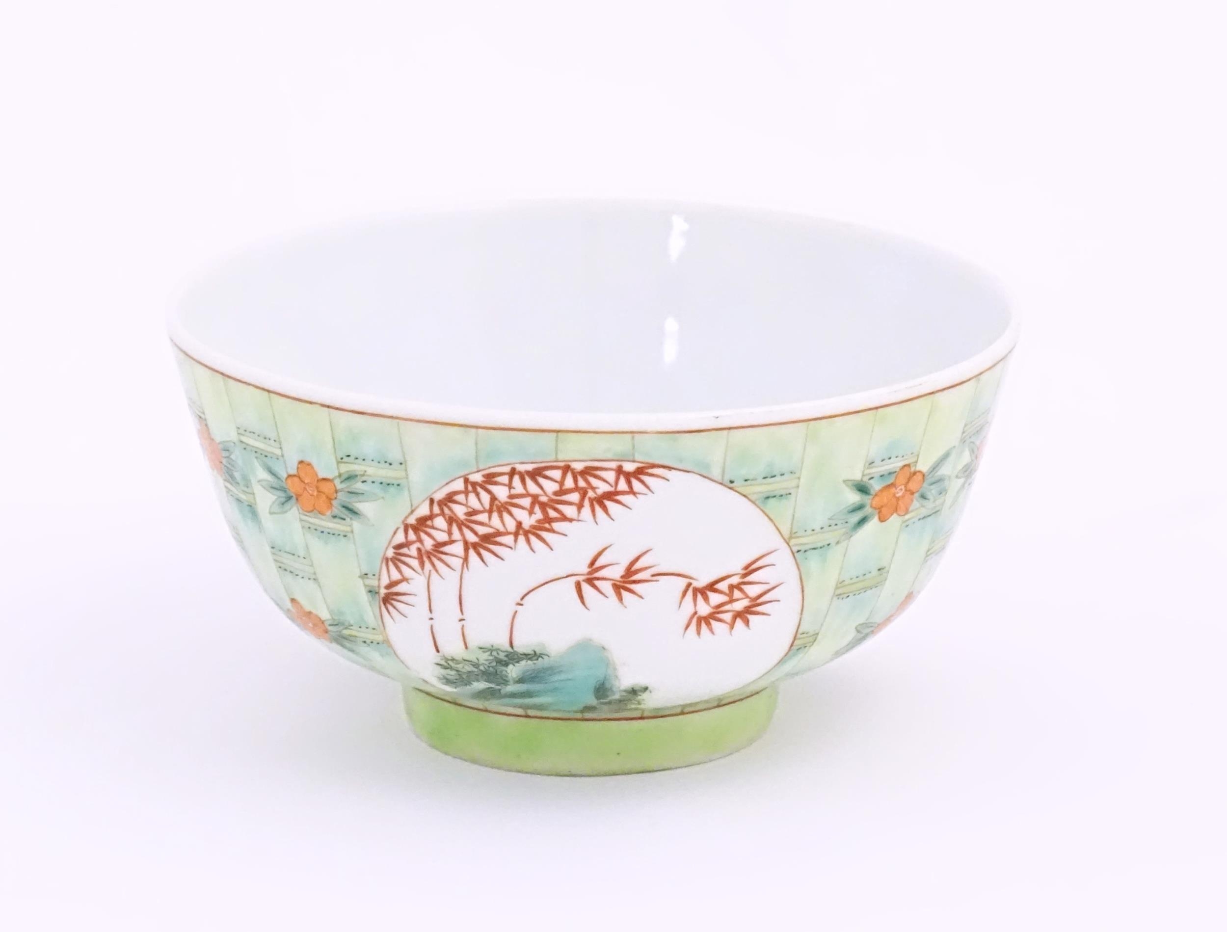 A small Chinese bowl decorated with stylised bamboo and flowers. Character marks under. Approx. 2 - Image 2 of 8