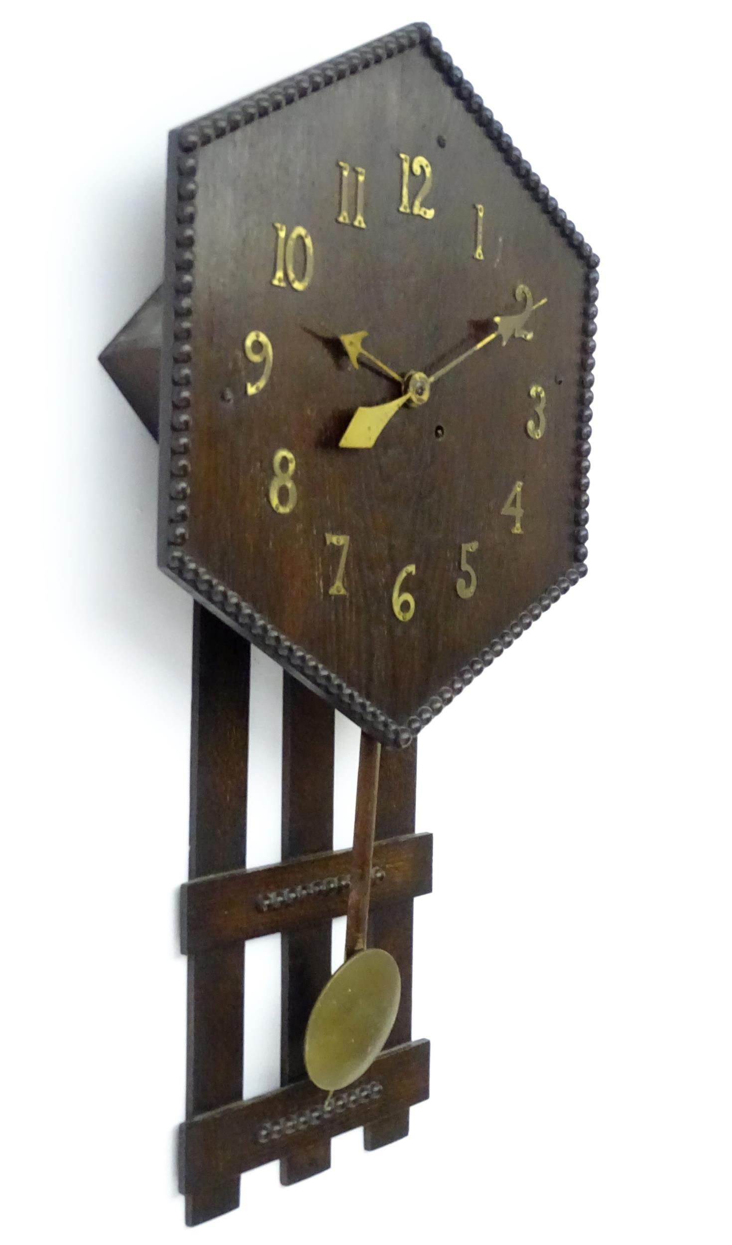 An Arts and Crafts style oak wall clock, the hexagonal dial with Arabic brass numerals and - Image 3 of 9
