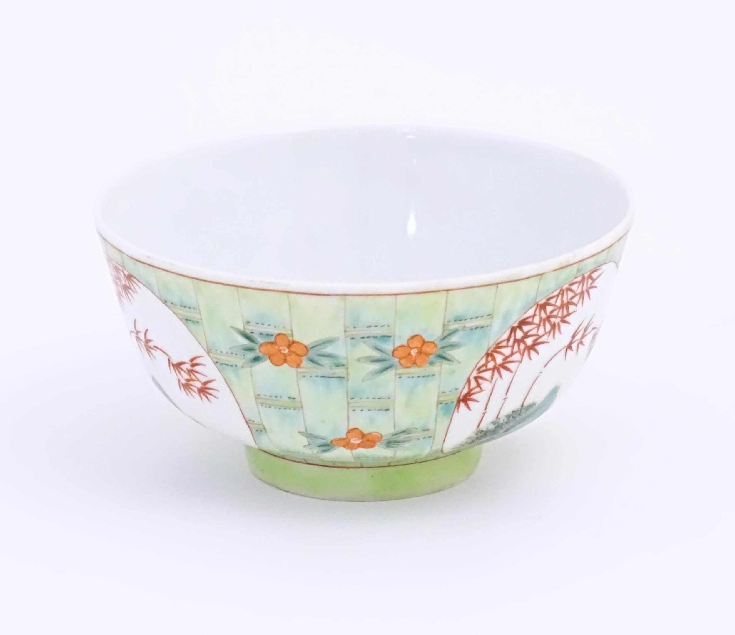 A small Chinese bowl decorated with stylised bamboo and flowers. Character marks under. Approx. 2 - Image 4 of 8