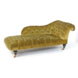 A mid 19thC chaise longue with a scrolled arm, shaped back and deep buttoned upholstery, the