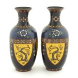 A pair of Oriental cloisonne vases decorated with panels of dragons and phoenix birds, the shoulders