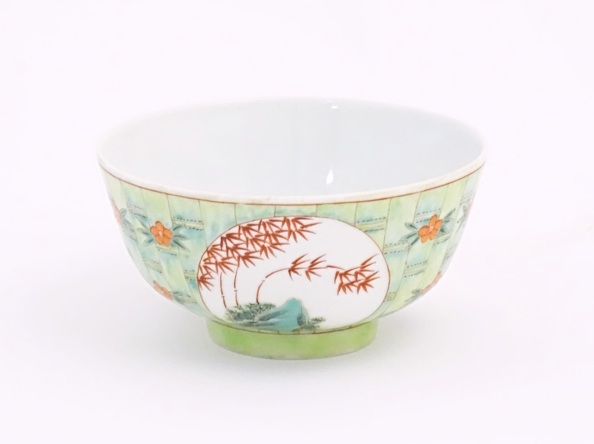 A small Chinese bowl decorated with stylised bamboo and flowers. Character marks under. Approx. 2 - Image 5 of 8