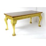 An early 20thC console table with a burr yew veneered top above a gilt painted base with Greek key