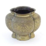 A Chinese brass lobed pot decorated with dragons, phoenix birds and pagoda buildings. Character