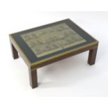 A late 20thC coffee table with a rectangular glazed top containing a French naval print, the table