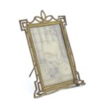 A Victorian brass easel back photo frame with floral detail. Approx. 8 3/4" high Please Note - we do