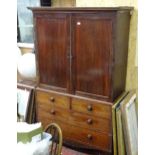 An early 19thC mahogany linen press, having a moulded cornice above two panelled doors and the