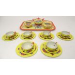 Toys: A 20thC Chad Valley tinplate tea set in bright yellow decorated with sprays of flowers and