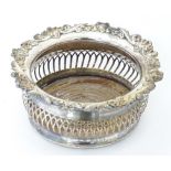 A silver plate bottle coaster with a turned wooden base and pierced gallery side. Approx. 7" wide