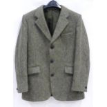 A Harris Tweed hacking jacket by Gurtex, with three buttons to front and single vent to rear,