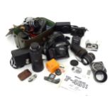 A quantity of film and digital cameras to include a cased Nikon F-401s camera, a cased Pentacon