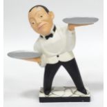 A small novelty dumb waiter figure formed as a waiter holding two dishes. Approx 21 1/2" high Please