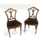 A pair of early 20thC walnut side chairs raised on fluted tapering front legs Please Note - we do