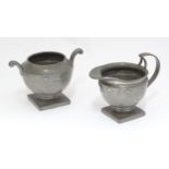 A pewter pedestal cream jug and sugar bowl with hammered and banded decoration. Stamped under Don