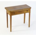 A late 19thC / early 20thC mahogany fold over card table with a single short drawer above four