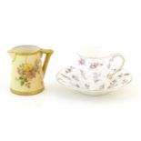 A Royal Worcester coffee cup and saucer decorated with flowers, foliage and berries. Marked under.