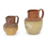 A Doulton Lambeth two tone jug with relief decoration. Together with a two tone stoneware jug with