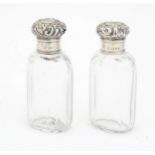 A pair of Victorian cut glass perfume / vanity bottles with silver lids hallmarked London 1892. 3