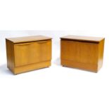Vintage / Retro: A pair of teak cabinets, each with two doors and a shelf to the interior, the
