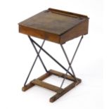 A mid 20thC child's student desk, with a sloped hinged top and a metal and pine constructed