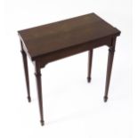 A late 19thC / early 20thC mahogany card table with satinwood inlay, a crossbanded top and