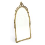 A brass framed mirror of arched form, approx 14" wide x 27" high Please Note - we do not make