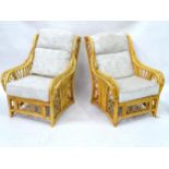 A pair of faux bamboo armchairs. Approx 30" wide x 43" high Please Note - we do not make reference