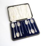 A cased set of six silver plate teaspoons with sugar tongs en suite Please Note - we do not make