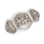 An Eastern white metal 3-part buckle with figural and scroll decoration, possibly Burmese Please