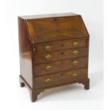 A mid 18thC mahogany bureau with a fall front above four long drawers with shaped back plates and