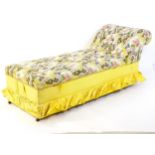 An early / mid 20thC chaise longue with deep buttoned floral upholstery and raised on four