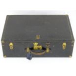 An early 20thC Oshkosh steamer trunk. the leather and wood case having studwork detailing and