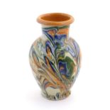 A terracotta vase with agate ware / marbled glaze. Approx. 6 3/4" high Please Note - we do not